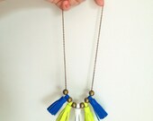 Necklace with blue, neon yellow and white leather pompoms