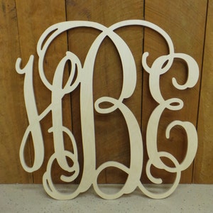 May include: A light-colored wooden cutout featuring a large, decorative, interlocking monogram of the letters H, B, and E in a cursive script font. The letters are connected by flowing, elegant lines, creating a single, cohesive piece of wall decor.