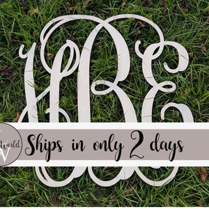 May include: White wooden monogram with the letters L, R, and E in a cursive script style. The monogram is on a green grassy background.