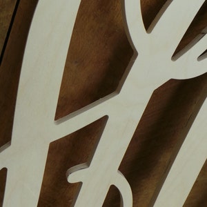 May include: A light-colored, flat wooden cutout featuring intricate, curved, and branching organic shapes. The surface of the wood is smooth and pale, showcasing a natural grain pattern with precise, laser-cut edges forming a decorative design.