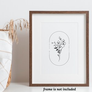 May include: A black and white line drawing of a bouquet of sweet pea flowers in an oval frame. The text "Sweet Pea" and "April" are written vertically on either side of the frame.