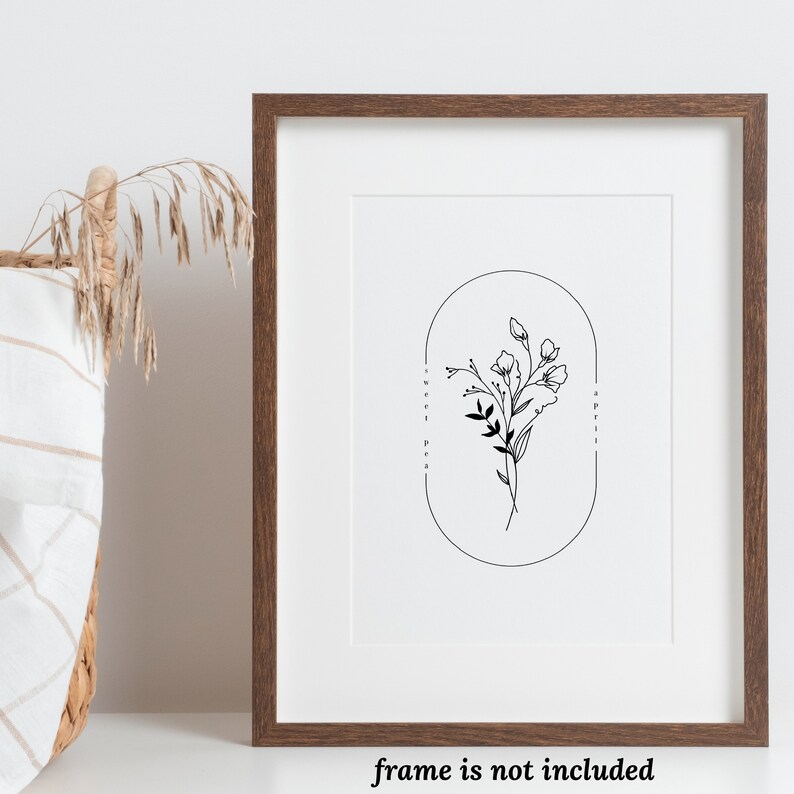 May include: A black and white line drawing of a bouquet of sweet pea flowers in an oval frame. The text "Sweet Pea" and "April" are written vertically on either side of the frame.
