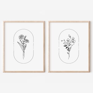 May include: Two black and white line drawings of flowers in oval frames. The first image is a daisy with the text "Daisy April" and the second image is a sweet pea with the text "Sweet Pea April".