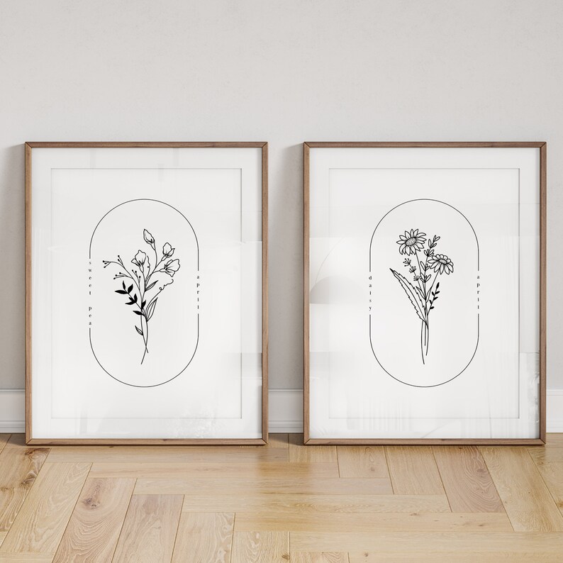 May include: Two framed black and white line drawings of flowers. The left drawing features a bouquet of sweet peas with the text "sweet pea, april" and the right drawing features a bouquet of daisies with the text "daisy, april".