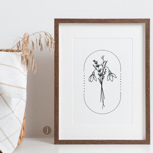 May include: A framed print featuring a botanical illustration of snowdrop flowers. The artwork includes a bouquet of white snowdrops with green stems and leaves, set against a white background. The text "snowdrop" and "January" are printed on the frame.