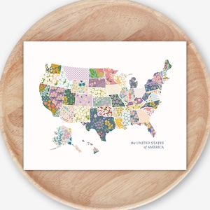 May include: A rectangular print featuring a map of the United States of America, where each state is filled with a unique floral or geometric pattern in various pastel and bold colors. The text the UNITED STATES of AMERICA is printed in blue.