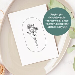 May include: Black and white line art print of a daisy flower bouquet in an oval frame. The text "daisy" is written on the left side of the frame and "april" is written on the right side of the frame.