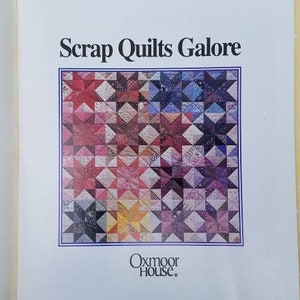 May include: Open book with the title "Scrap Quilts Galore" and a colorful star quilt pattern on the cover. The Oxmoor House logo is at the bottom. The background is a light yellow with white polka dots.
