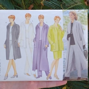 May include: A Butterick sewing pattern envelope featuring illustrations of women's coats and suits in various colors. The pattern number is 6213, with the text "Today's Wardrobe" and size range 8-10-12. The background is a blurred view of green palm leaves.
