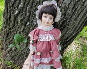Ashley porcelain doll from Wyndham Lane with hand painted features, brown hair, dusty rose dress and bonnet with white lace, girl birthday