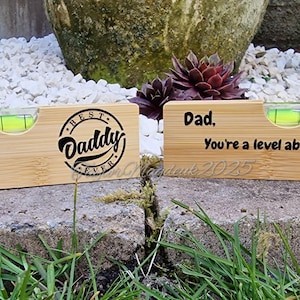 May include: Two wooden level tools with a bottle opener and a level. The first level has the text "Best Daddy Ever" engraved on it. The second level has the text "Dad, You're a level above the rest! Love Ben & Ryan xxx" engraved on it.