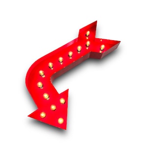May include: A red metal arrow sign with light bulbs. The arrow is pointing to the left and down.