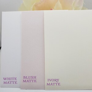 May include: Three cardstock samples in white, blush, and ivory matte finishes. The text on the cards reads "White Matte", "Blush Matte", and "Ivory Matte".