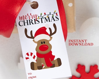 May include: A printable Christmas gift tag featuring a cartoon reindeer wearing a Santa hat and a red scarf. The tag says "merry CHRISTMAS" and has a space to write "TO:" and "FROM:".