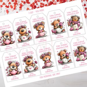May include: A sheet of printable Valentine's Day gift tags. Each tag features a teddy bear in a teacup, decorated with flowers and scarves. The tags read "Have a sweet Valentine's Day!" and "Love, Catherine."