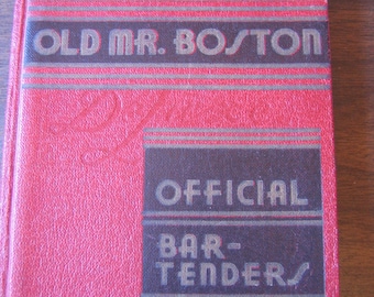 May include: A vintage red "Old Mr. Boston Official Bartender's Guide" book. The cover features the text "OLD MR. BOSTON" in dark lettering, a circular illustration of a man in a top hat, and the words "OFFICIAL BARTENDER'S GUIDE".