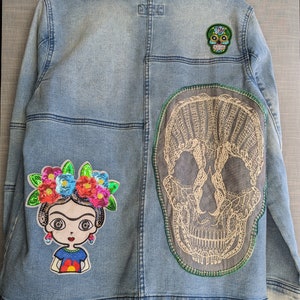 Women&#39;s Denim Trucker Jacket in Light Mid Indigo Wash with Lace Sugar Skull Hand Stitched Applique