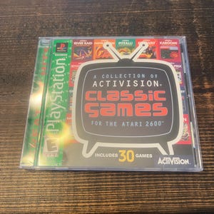 May include: A clear plastic case containing a PlayStation game and a retro Activision Classic Games compilation for the Atari 2600. The compilation features a television graphic and includes 30 games.
