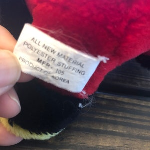 May include: A white tag with black text that reads "All New Material Polyester Stuffing MFR - 105 Product of Korea".