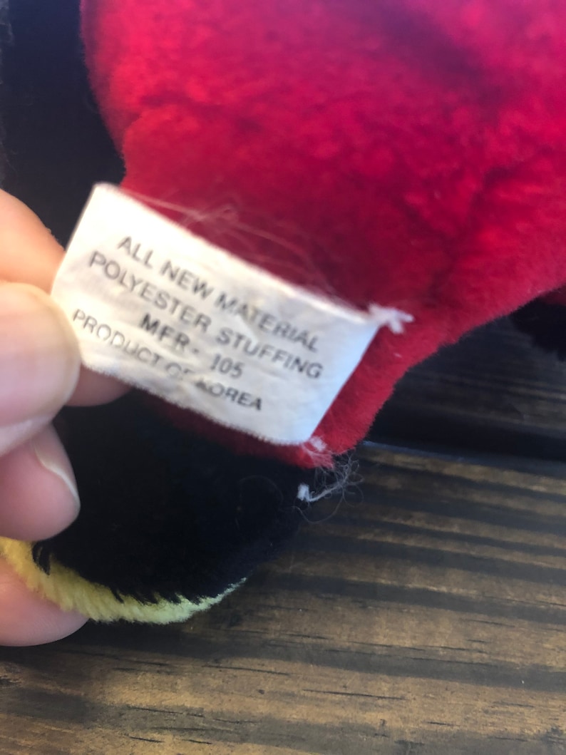 May include: A white tag with black text that reads "All New Material Polyester Stuffing MFR - 105 Product of Korea".