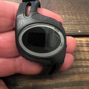 May include: Black digital watch with the text "MODE" and "SET". The watch has a black strap and a digital display. The brand name "ARMORALL" is visible on the watch face.
