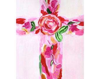 May include: A painting of a cross on a light pink background, featuring thick, textured brushstrokes in shades of bright pink, red, and white. The cross is decorated with painted floral elements, including a large central rose and green leaves.