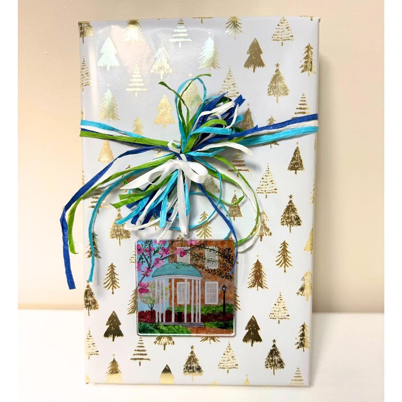UNC Old Well ornament displayed as Southern-inspired Christmas tree decor, an addition to your gift wrap and year-round keepsake.
University of North Carolina Chapel Hill ornament with iconic Old Well artwork printed on durable acrylic.