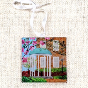 UNC Old Well acrylic Christmas ornament featuring Jeanne Player’s original artwork. Lightweight, shatterproof 4x4-inch square with adjustable satin ribbon. Perfect holiday décor or year-round gift for UNC Tar Heels fans, students, alumni, and graduates. UNC Chapel Hill Graduation Gift Idea.