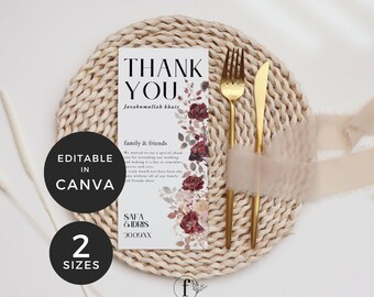 May include: A wedding thank you card with the text "THANK YOU" and floral accents. The card is on a woven placemat with gold cutlery and a ribbon. The card is editable in Canva and available in two sizes.