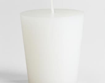 May include: A plain white votive candle with a small wick.