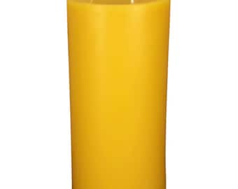 May include: A large, yellow pillar candle with three wicks.