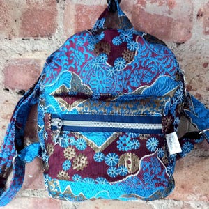 Upcycled backpack with 2 pockets adjustable straps,  lightweight and lined,  one external  and one internal pocket. upcycled using curtains.