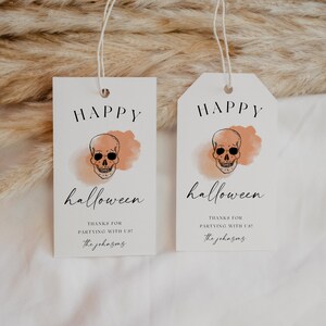 May include: Two white Halloween gift tags with a skull illustration and the words "Happy Halloween." The tags also include the text "Thanks for partying with us!" and a signature.