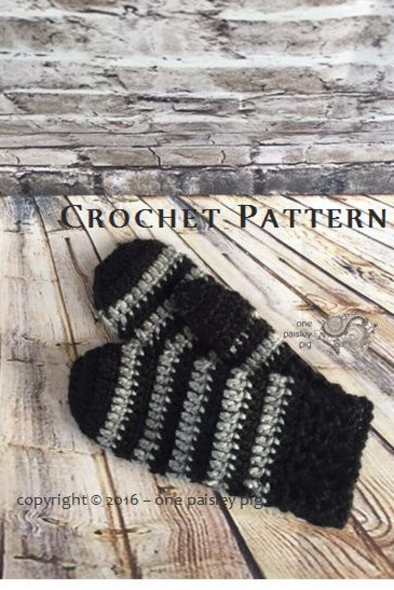 May include: A pair of crocheted mittens featuring alternating horizontal stripes of black and grey yarn. The text CROCHET PATTERN is visible at the top, and the text copyright &copy; 2016 &ndash; one paisley pig is visible at the bottom of the image.