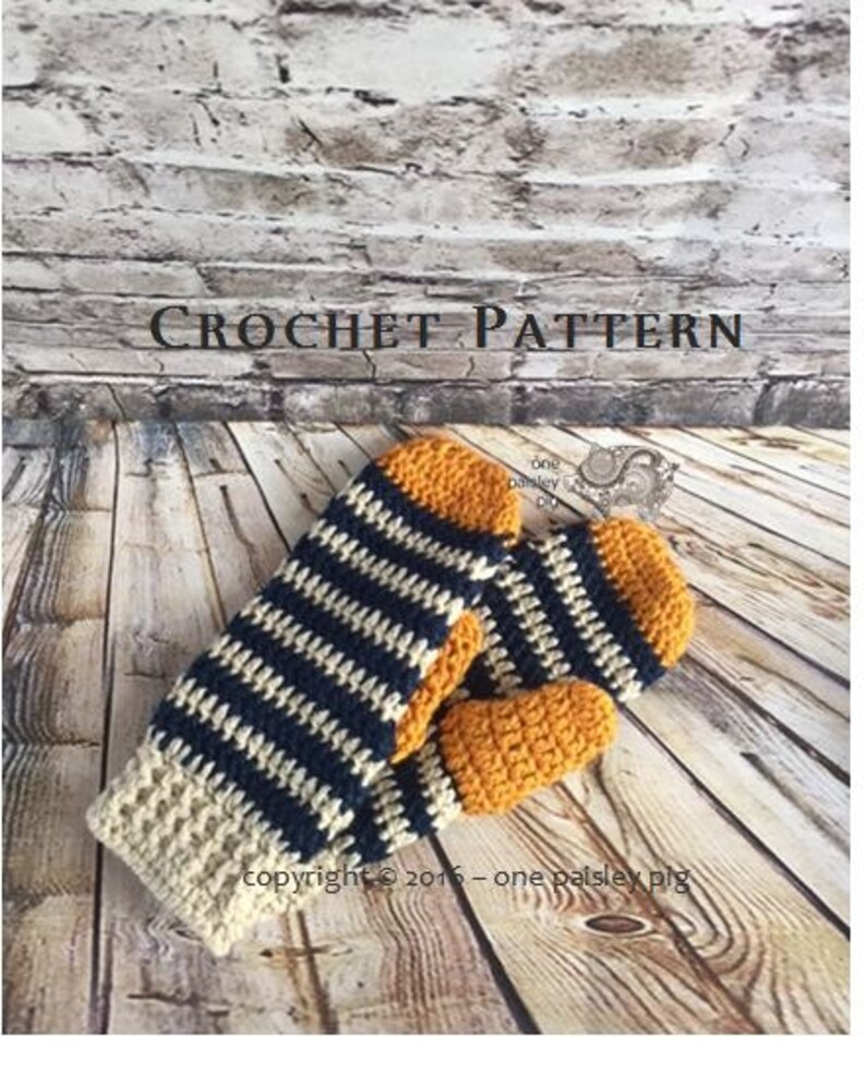May include: A pair of crochet mittens featuring a striped pattern in navy blue, cream, and mustard yellow. The mittens have a solid mustard yellow thumb and rounded tip, with a cream-colored cuff. The text CROCHET PATTERN is visible.