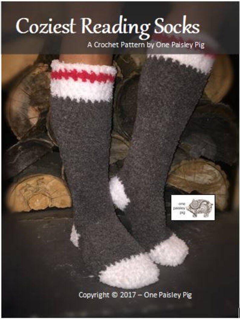 May include: A pair of gray crochet reading socks with white and red stripes at the top. The socks are sitting on a pile of logs. The text "Coziest Reading Socks" and "A Crochet Pattern by One Paisley Pig" is at the top of the image. The text "Copyright &copy; 2017 - One Paisley Pig" is at the bottom of the image.