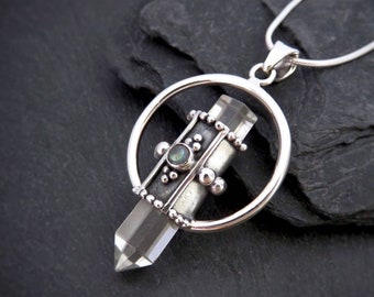 mountain crystal pendant with a circle, dots and a small stone silver