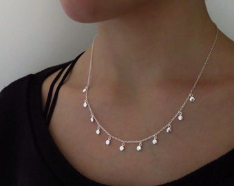 silver necklace with small round dangling pendants