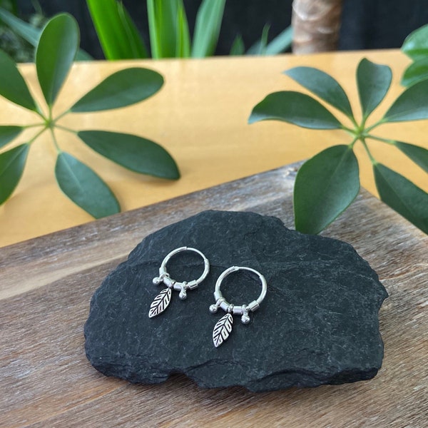 small silver hoop earrings with little leaf