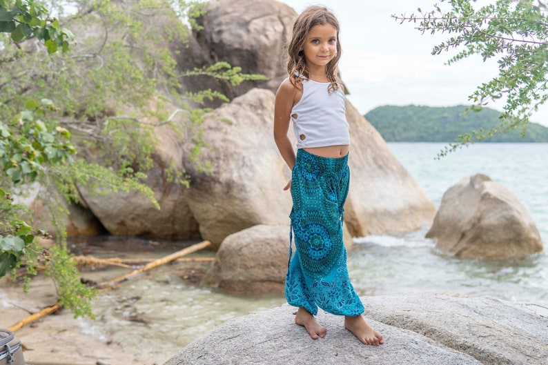 turquoise kids pants with two pockets image 1