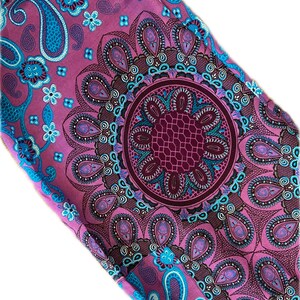 May include: Purple fabric with a blue and white paisley pattern. The fabric features a large, intricate mandala design in the center.