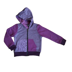 May include: Purple zip-up hoodie with a geometric pattern on the sleeves and a paisley pocket on the front.