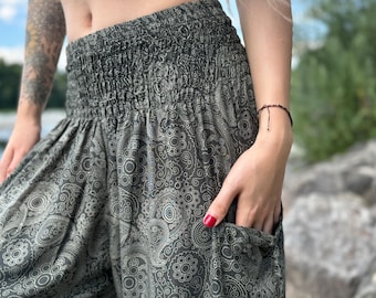 May include: Gray paisley print pants with a drawstring waist and a pocket on the side.
