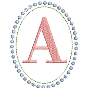 May include: An embroidery design featuring a capital letter A in a soft pink thread color. The letter is centered within an oval frame composed of a thin green stitched line and an outer border of small, light blue circular floral motifs.