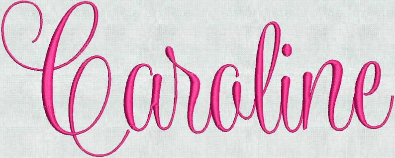May include: The name Caroline is embroidered in a vibrant hot pink thread using a flowing, cursive script font. The lettering is stitched onto a light, off-white fabric background, creating a clear contrast between the pink text and the base.