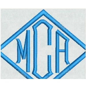 May include: A bright blue embroidered monogram featuring the letters MCA centered within a diamond-shaped border. The design is stitched onto a white fabric background, showcasing a clean, uniform thread texture throughout the entire graphic.