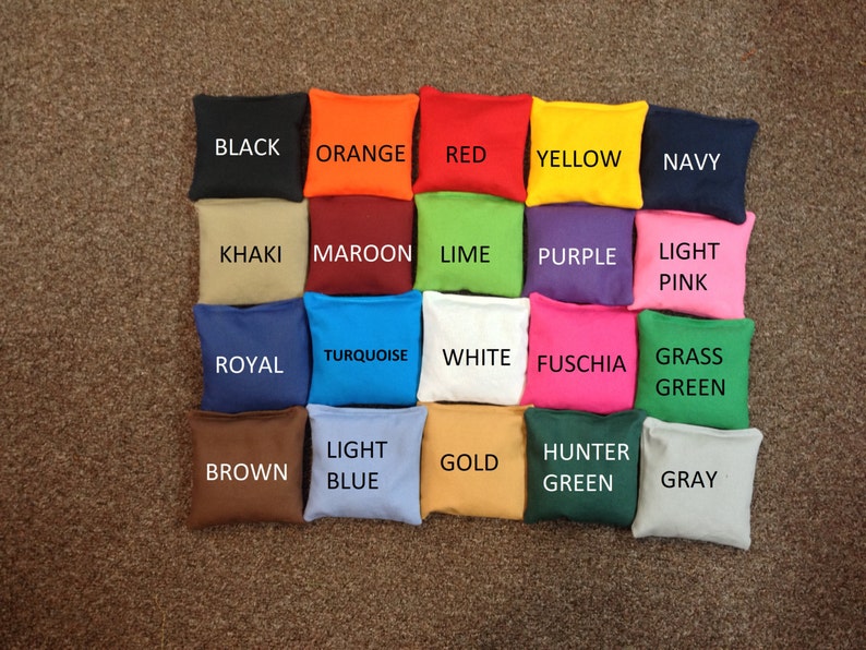 May include: A collection of twenty bean bags in various colors, including black, orange, red, yellow, navy, khaki, maroon, lime, purple, light pink, royal, turquoise, white, fuchsia, grass green, brown, light blue, gold, hunter green, and gray. Each bag has a color label.