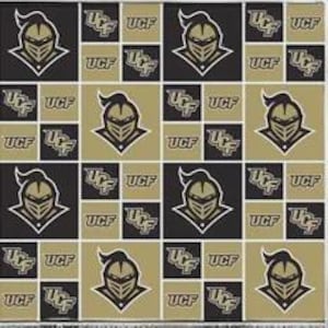 May include: A repeating pattern fabric featuring the UCF Knights logo and the text UCF in black and gold. The design consists of alternating square blocks, with some squares displaying the knight helmet emblem and others showing the UCF acronym.