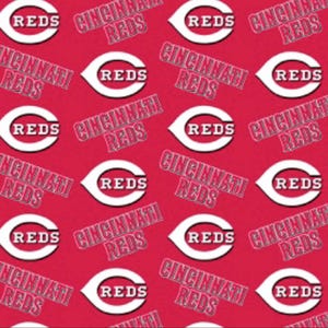 May include: A red fabric pattern featuring the Cincinnati Reds logo, which consists of a white letter C with the word REDS in white letters inside, alternating with the text CINCINNATI REDS printed in a white font with a black outline.