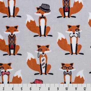 May include: A light gray fabric featuring a repeating pattern of cartoon foxes. The foxes are orange and white, dressed in various outfits including bow ties, hats, and vests. The fabric is measured in inches.